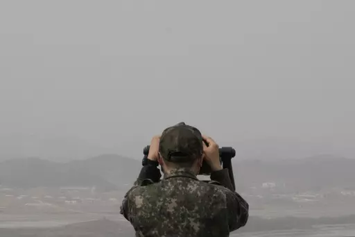 A South Korean army soldier watches the North Korea side from the Unification Observation Post in Paju, South Korea, near the border with North Korea, Friday, March 24, 2023. North Korea said Friday its cruise missile launches this week were part of nuclear attack simulations that also involved a detonation by a purported underwater drone as leader Kim Jong Un vowed to make his rivals "plunge into despair." (AP Photo/Ahn Young-joon)