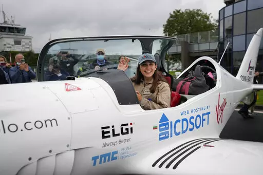Belgian-British teenager Zara Rutherford waves from her Shark ultralight plane prior to take off at the Kortrijk-Wevelgem airfield in Wevelgem, Belgium, Aug. 18, 2021. Rutherford is set to land in Kortrijk, Belgium on Monday, Jan. 17, 2022, in the hopes of completing her trek around the world as the youngest woman ever, beating the mark of American aviator Shaesta Waiz, who was 30 when she set the previous benchmark. (AP Photo/Virginia Mayo, File)