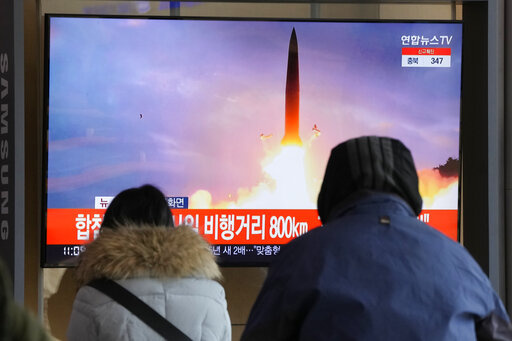 People watch a TV showing a file image of North Korea's missile launch during a news program at the Seoul Railway Station in Seoul, South Korea, Sunday, Jan. 30, 2022. North Korea on Sunday fired what appeared to be the most powerful missile it has tested since U.S. President Joe Biden took office, as it revives its old playbook in brinkmanship to wrest concessions from Washington and neighbors amid a prolonged stalemate in diplomacy. (AP Photo/Ahn Young-joon)