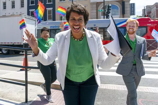 District of Columbia Mayor Muriel Bowser, center, arrives for a news conference ahead of DC Pride events, Friday, June 10, 2022, in Washington. At right is Japer Bowles, director of the Mayor's Office of Lesbian, Gay, Bisexual, Transgender and Questioning Affairs. Bowser is seeking a third term in office. (AP Photo/Jacquelyn Martin)