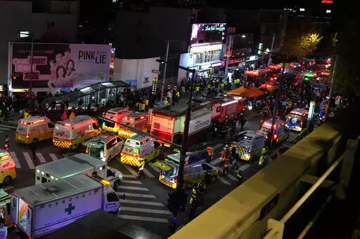Ambulances and rescue workers arrive at the street near the scene of a crowd surge in Seoul, South Korea, Oct. 30, 2022. The Halloween party crush in Seoul has caused an outpouring of public sympathy toward the 150 dead, but there's also a strong level of embarrassment and anger from citizens toward the country that they say still ignores safety and regulatory issues. (AP Photo/Lee Jin-man, File)