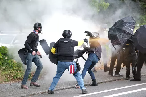 Members of the far-right group Proud Boys and anti-fascist protesters spray bear mace at each other during clashes between the politically opposed groups in Portland, Ore., Aug. 22, 2021. Over the past decade, Oregon experienced the sixth-highest number of extremist incidents in the nation, despite being 27th in population, according to an Oregon Secretary of State report. Now, the state Legislature is considering a bill that, experts say, would create the nation's most comprehensive law against