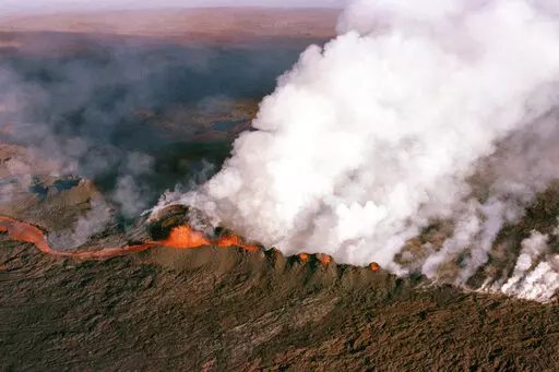 A gaseous cloud rises from the crater of Mauna Loa, center, on the big island of Hawaii, April 4, 1984. The ground is shaking and swelling at Mauna Loa, the largest active volcano in the world, indicating that it could erupt. Scientists say they don't expect that to happen right away but officials on the Big Island of Hawaii are telling residents to be prepared in case it does erupt soon. (AP Photo/John Swart, File)