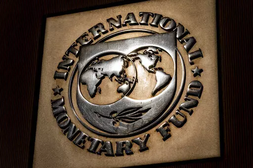 The logo of the International Monetary Fund is visible on their building, April 5, 2021, in Washington. The IMF is facing pressure to eliminate, or at least, reevaluate how it imposes fees on loans it disperses to needy countries like war-torn Ukraine — which is one of the fund's biggest borrowers. (AP Photo/Andrew Harnik)