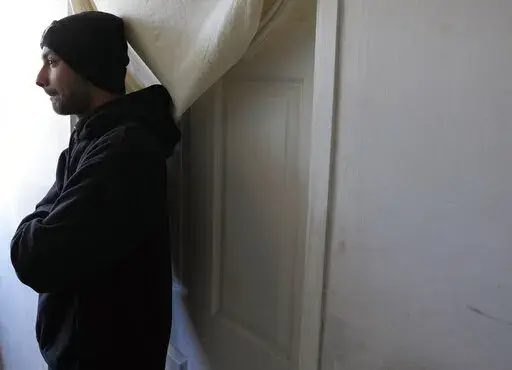 Hasib Qarizada a student from Afghanistan stands outside his room in the "Krnjaca" refugee centre near Belgrade, Serbia, Thursday, Feb. 24, 2022. While tens of thousands of refugees from Ukraine have found safety and help in Hungary, thousands of others weren't so lucky. Among them was Hasib Qarizada, a 25-year-old student from Afghanistan. He had been studying in Hungary for years butwas expelled last September even as his native country unraveled. (AP Photo/Darko Vojinovic)