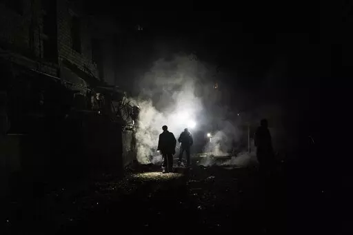 Resident walks amid debris after a Russian attack in Kherson, southern Ukraine, Nov. 24, 2022. In a deliberate, widespread campaign, Russian forces systematically targeted influential Ukrainians, nationally and locally, to neutralize resistance through detention, torture and executions, an Associated Press investigation has found. (AP Photo/Bernat Armangue, File)