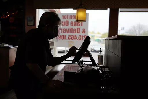 An order is entered by an employee at a diner on Nov. 17, 2020, in Philadelphia. It's never fun to be scammed, but if you're a small business owner falling for a scam can have long-lasting effects on a business, damaging client relationships and profit. (AP Photo/Matt Slocum, File)