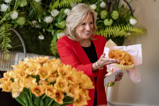 First lady Jill Biden holds a bouquet of the newest tulip named "Jill Biden" in a ceremony formally naming the flower in honor of the first lady during Dutch Tulip Days at the Embassy of the Kingdom of the Netherlands, Wednesday, April 5, 2023, in Washington. (AP Photo/Andrew Harnik)