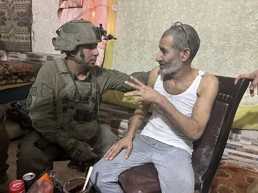 In this photo released by Israeli Defense Forces on Aug. 27, 2024, Qaid Farhan Alkadi, right, and the commanding officer of the 162nd Division, Brig. Gen. Itzik Cohen, talk after a rescue operation to free Alkadi. (Israeli Defense Forces via AP, File)