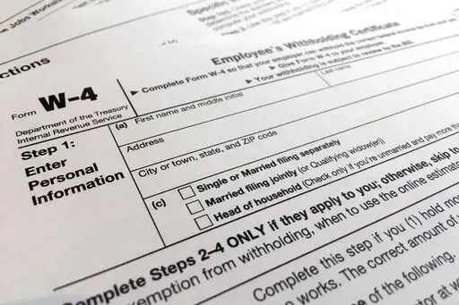 A W-4 form on Feb. 5, 2020, in New York. Monday is Tax Day, the federal deadline for individual tax filing and payments. The IRS will receive tens of millions of filings electronically and through paper forms. (AP Photo/Patrick Sison, File)