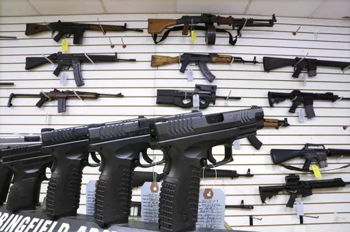 Semi-automatic guns are displayed for sale at Capitol City Arms Supply, Jan. 16, 2013, in Springfield, Ill. Illinois will soon outlaw advertising for firearms that officials determine produces a public safety threat or appeals to children, militants or others who might later use them illegally, as the state continues its quest to curb mass shootings. (AP Photo/Seth Perlman, File)