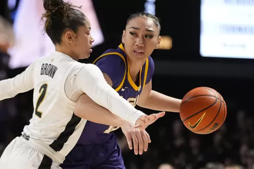 LSU guard Last-Tear Poa, right, dribbles the ball past Vanderbilt guard Jada Brown (2) during the first half of an NCAA college basketball game Thursday, Feb. 8, 2024, in Nashville, Tenn. (AP Photo/George Walker IV)