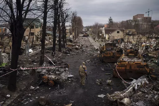 A Ukrainian serviceman walks amid destroyed Russian tanks in Bucha, on the outskirts of Kyiv, Ukraine, April 6, 2022. Russia is bracing up for a massive new offensive in eastern Ukraine, hoping to reverse its fortunes on the battlefield after a catastrophic start of the invasion. (AP Photo/Felipe Dana, File)