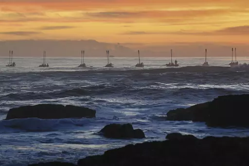 Surf boats perform during the Anzac Day dawn service at Elephant Rock in Currumbin on the Gold Coast, Australia, Thursday April 25, 2024. (Jono Searle/AAP Image/via AP)