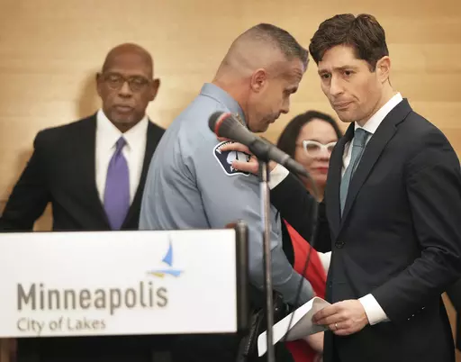 Minneapolis Mayor Jacob Frey, right, pats the shoulder of Minneapolis Police Chief Brian O'Hara after O' Hara spoke during a press conference announcing approval of a sweeping plan to reform policing that aims to reverse years of systemic racial bias Friday, March 31, 2023 at the Minneapolis Public Service Building in Minneapolis. The Minneapolis City Council on Friday approved an agreement with the state to revamp policing, nearly three years after a city officer killed George Floyd. (David Jol