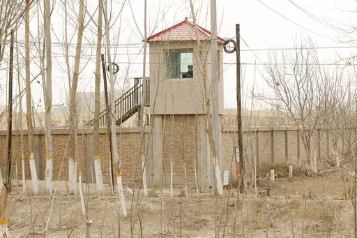 A security guard watches from a tower around a detention facility in Yarkent County in northwestern China's Xinjiang Uyghur Autonomous Region on March 21, 2021. As world leaders gather in New York at the annual U.N. General Assembly, rising superpower China is also focusing on another United Nations body that is meeting across the Atlantic Ocean in Geneva.  (AP Photo/Ng Han Guan, File)