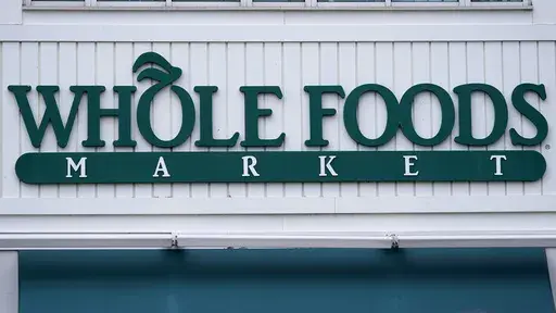 The Whole Foods Market logo is shown on the front of a store, July 14, 2021, in Cambridge, Mass. (AP Photo/Charles Krupa, File)