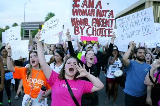 Protesters in Phoenix shout as they join thousands marching around the Arizona state Capitol after the U.S. Supreme Court decision to overturn the landmark Roe v. Wade abortion decision on June 24, 2022. Three state supreme courts are scheduled to hear arguments in abortion-related cases this week. (AP Photo/Ross D. Franklin, File)