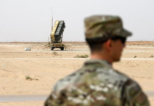 A member of the U.S. Air Force stands near a Patriot missile battery at the Prince Sultan air base in al-Kharj, central Saudi Arabia, on Feb. 20, 2020. The U.S. has transferred a significant number of Patriot antimissile interceptors to Saudi Arabia in recent weeks as the Biden administration looks to ease what has been a point of tension in the increasingly complicated U.S.-Saudi relationship.   (Andrew Caballero-Reynolds/Pool via AP, File)
