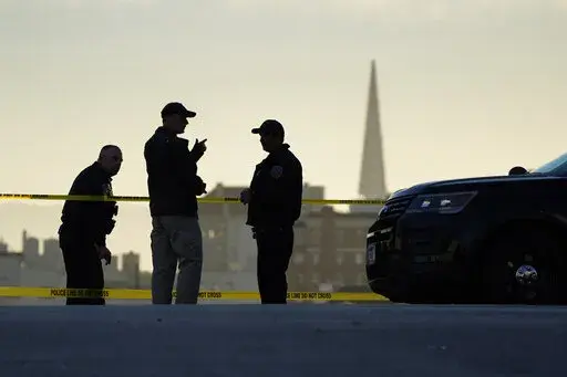 Police stand at the top of the closed street outside the home of House Speaker Nancy Pelosi and her husband Paul Pelosi in San Francisco, Friday, Oct. 28, 2022. Within hours of the attack on Paul Pelosi, conspiracy theories deflecting blame for the assault on the husband of U.S. Speaker Nancy Pelosi were already swirling online. (AP Photo/Eric Risberg, File)