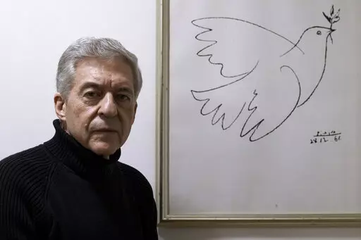 Yossi Beilin, a former senior Israeli official and peace negotiator who co-founded the Geneva Initiative, poses for a photo at his house in Tel Aviv, Israel, Sunday, Feb. 6, 2022. Israeli and Palestinian public figures, including Beilin and Hiba Husseini, a former legal advisor to the Palestinian negotiating team who hails from a prominent Jerusalem family, have drawn up a new proposal for a two-state confederation that they hope will offer a way forward after a decade-long stalemate in Mideast 