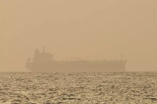 An oil tanker is moored off Fujairah, United Arab Emirates, Wednesday, Aug. 4, 2021. Technology to hide a ship's location previously available only to the world's militaries is spreading fast through the global maritime industry as governments from Iran to Venezuela — and the rogue shipping companies they depend on to move their petroleum products — look for stealthier ways to circumvent U.S. sanctions. (AP Photo/Jon Gambrell)