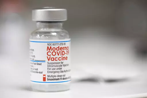 A vial of the Moderna COVID-19 vaccine is displayed on a counter at a pharmacy in Portland, Ore. on Dec. 27, 2021. U.S. health authorities are facing a critical decision: whether to offer COVID-19 booster shots this fall that better match the omicron variant even though the coronavirus already has spawned still more mutants. Moderna and Pfizer are testing updated booster candidates, and advisers to the U.S. Food and Drug Administration will debate Tuesday, June 28, 2022, if it’s time for a swi