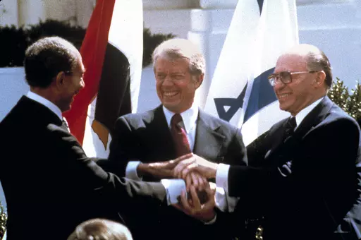 Egyptian President Anwar Sadat, left, U.S. President Jimmy Carter, center, and Israeli Prime Minister Menachem Begin clasp hands on the North lawn of the White House as they completed signing of the peace treaty between Egypt and Israel in Washington on March, 26, 1979. Egypt has threatened to void its decades-long peace treaty with Israel if Israel begins a large-scale offensive on Rafah, where some 1.4 million Palestinians shelter in densely-packed tent camps on the border with Egypt. (AP Phot