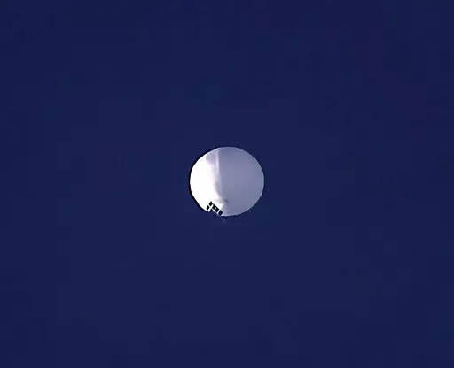 ADDS PENTAGON RESPONSE THAT IT WOULD NOT CONFIRM - A high altitude balloon floats over Billings, Mont., on Wednesday, Feb. 1, 2023. The U.S. is tracking a suspected Chinese surveillance balloon that has been spotted over U.S. airspace for a couple days, but the Pentagon decided not to shoot it down due to risks of harm for people on the ground, officials said Thursday, Feb. 2, 2023. The Pentagon would not confirm that the balloon in the photo was the surveillance balloon. (Larry Mayer/The Billin