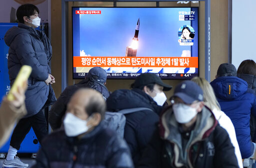 People watch a TV showing a file image of North Korea's missile launch during a news program at the Seoul Railway Station in Seoul, South Korea, March 5, 2022.  The Biden administration says two North Korean missile launches in recent weeks were in fact test-firings of a new intercontinental ballistic missile. And the administration is warning that a full-range test could soon follow. (AP Photo/Ahn Young-joon, File)