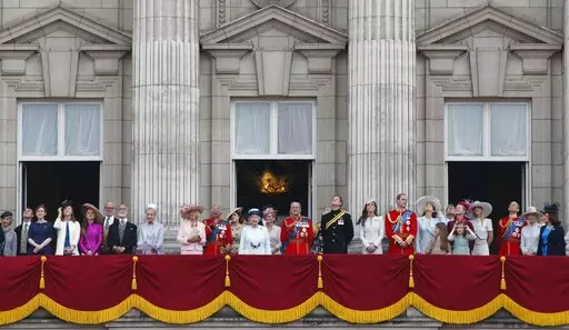 Britain's Queen Elizabeth II, surrounded by members of the family, stand on the balcony of Buckingham Palace to watch the fly past after the Trooping The Colour parade, in central London, Saturday, June 14, 2014. The balcony appearance is the centerpiece of almost all royal celebrations in Britain, a chance for the public to catch a glimpse of the family assembled for a grand photo to mark weddings, coronations and jubilees. (AP Photo/Lefteris Pitarakis, File)