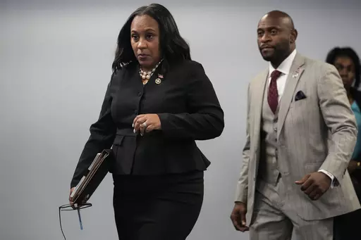 Fulton County District Attorney Fani Willis, followed by special prosecutor Nathan Wade, right, arrives for a news conference at the Fulton County Government Center, Monday, Aug. 14, 2023, in Atlanta. Willis acknowledged in a court filing on Friday, Feb. 2, 2024, having a “personal relationship” with Wade, a special prosecutor she hired for the Georgia election interference case against former President Donald Trump, but argued there are no grounds to dismiss the case or to remove her from t