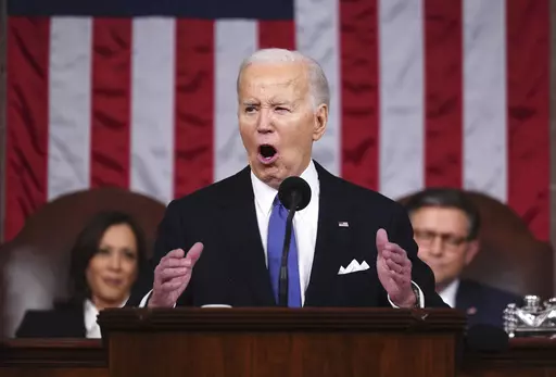 President Joe Biden delivers the State of the Union address to a joint session of Congress at the Capitol, March 7, 2024, in Washington. Seated at left is Vice President Kamala Harris and at right is House Speaker Mike Johnson, R-La. Biden made abortion and reproductive rights a central theme of his State of the Union speech, but he never mentioned the word "abortion." Pushback over how he addressed the issue is the latest example of Biden's fraught history with the topic. (Shawn Thew/Pool via A