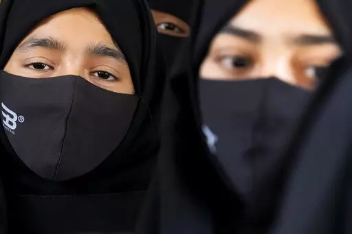 Indian Muslim students wearing hijabs and face masks gather to meet student activists in Kundapur in district Udupi, Karnataka state, India, Saturday, Feb. 26, 2022. An Indian court ruling upholding a ban on Muslim students wearing head coverings in schools has sparked criticism from constitutional scholars and rights advocates amid concerns of judicial overreach regarding religious freedoms. (AP Photo/Aijaz Rahi)