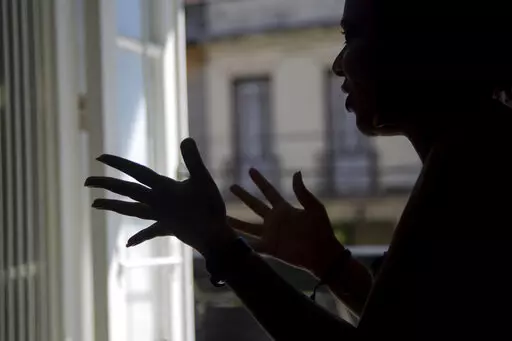 Diana gives an interview in Havana, Cuba, Thursday, Nov. 3, 2022. Diana said she endured screams, insults and confinement for seven years before she ended a seven year relationship with her boyfriend, but that she did not reach out to any institutions or programs that handled cases of violence against women because she had no faith that they could protect her. Diana asked that her last name not be published because she was afraid for her safety.  (AP Photo/Ismael Francisco)