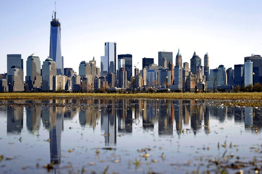 New York's Lower Manhattan skyline, including the One World Trade Center, left, is reflected in water on April 6, 2013, as seen from Liberty State Park in Jersey City, N.J. Eight of the 10 largest cities in the U.S. lost population during the first year of the pandemic, with only Phoenix and San Antonio gaining new residents from 2020 to 2021, according to new estimates released, Thursday, May 26, 2022, by the U.S. Census Bureau. (AP Photo/Mel Evans, File)