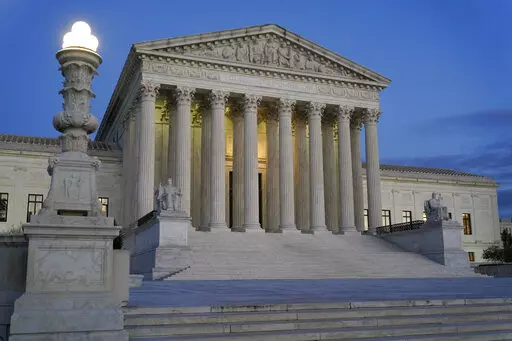 Light illuminates part of the Supreme Court building at dusk on Capitol Hill in Washington, Nov. 16, 2022. The Supreme Court has agreed to hear an appeal arising from a murder-for-hire ordered by the onetime leader of a violent international crime ring. The justices said Tuesday they will review the case of Adam Samia, who is serving a life sentence for killing a real estate broker in the Philippines. (AP Photo/Patrick Semansky, File)
