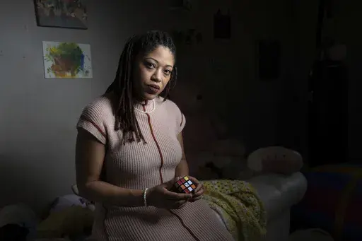 Natasha Nelson, who was diagnosed with autism in August 2023, just after her youngest daughter was also diagnosed, sits in a sensory room she uses to calm her children in her Stone Mountain, Ga. home on Friday, Feb. 14, 2025. (AP Photo/Ben Gray)