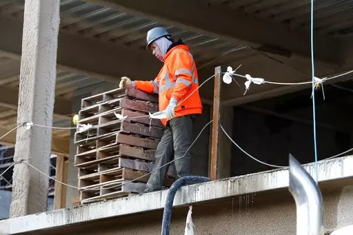 A construction worker pauses at a building site, Thursday, Jan. 26, 2023, in Boston. America's employers added a robust 517,000 jobs in January, a surprisingly strong gain in the face of the Federal Reserve's aggressive drive to slow growth and tame inflation with higher interest rates.(AP Photo/Michael Dwyer)