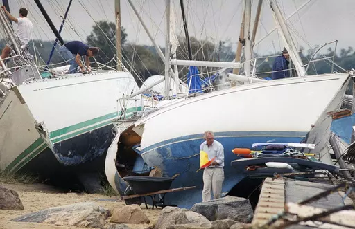 Boat owners gather their belongings along the shore in Dartmouth, Mass., Aug. 20, 1991, after Hurricane Bob swept through southern Massachusetts. New England is known for its fickle weather, powerful nor'easters and blizzards. Destructive hurricanes, however, are relatively rare and typically don't pack the same punch as tropical cyclones that hit the Southeast. Hurricanes usually lose some steam, becoming tropical storms, or extratropical storms, in northern waters. (AP Photo/Susan Walsh, File)