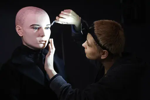 In this undated handout photo provided by The National Wax Museum Plus, Artistic Coordinator Mel Creek applies the finishing touches on a wax figure of the late singer Sinead O'Connor, at the National Wax Museum Plus on Dublin's Westmorland Street, Ireland. A wax figure of Sinéad O’Connor that did not compare to how the late singer looked caused a minor meltdown among fans and family members, leading a Dublin museum on Friday, July 26, 2024, to pull it from its collection. The National Wax Mu