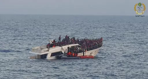File In this photo released by the Lebanese Army, shows Lebanese army on their dinghy, rescuing migrants from a boat sinking in the Mediterranean Sea, near the shores of Tripoli, north Lebanon, Saturday, Dec. 31, 2022. A short Lebanese army statement said the vessel was carrying people "who were trying to illegally leave Lebanon's territorial waters." It said three Lebanese navy boats and one from the U.N. peacekeeping force in Lebanon, known as UNIFIL, were rescuing the approximately 200 migran
