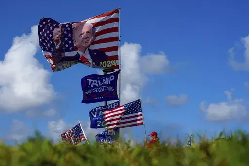 Supporters display MAGA flags near the Mar-a-Lago estate of President-elect Donald Trump, in Palm Beach, Fla., Nov. 12, 2024. (AP Photo/Julia Demaree Nikhinson, File)