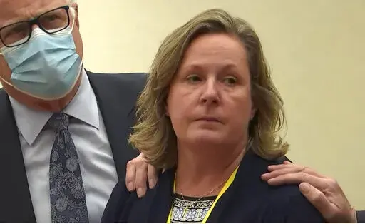 In this screen grab from video, former Brooklyn Center Police Officer Kim Potter stands with defense attorney Earl Gray, as the verdict is read Thursday, Dec.,23, 2021 at the Hennepin County Courthouse in Minneapolis, Minn.  Jurors on Thursday convicted Potter of two manslaughter charges in the killing of Daunte Wright, a Black motorist she shot during a traffic stop after she said she confused her gun for her Taser.(Court TV via AP, Pool)