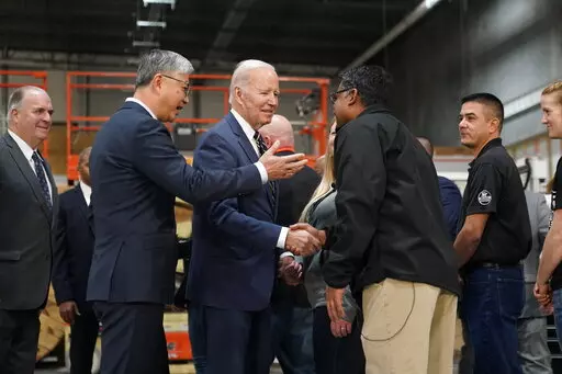 President Joe Biden tours SK Siltron CSS, a computer chip factory in Bay City, Mich., Tuesday, Nov. 29, 2022, with SK Siltron CSS CEO Jianwei Dong, second left. (AP Photo/Patrick Semansky)