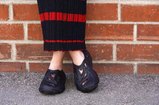 Plastic Soul shoes are modeled outside the Doc Johnson factory and corporate offices, Thursday, Aug. 18, 2022, in Los Angeles. Streetwear label Rose in Good Faith and sex toy company Doc Johnson have partnered to create a shoe derived in part from unused or defective sex toys. (AP Photo/Chris Pizzello)