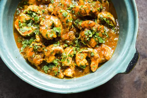 This image released by Milk Street shows a recipe for Shrimp with Tamarind & Cilantro. (Milk Street via AP)
