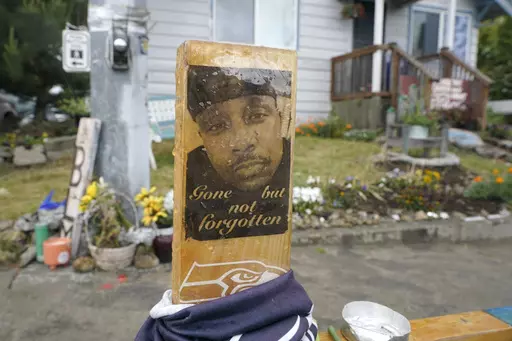 A sign is displayed on May 27, 2021, at a memorial in Tacoma, Wash., where Manuel "Manny" Ellis died March 3, 2020, after he was restrained by police officers. Opening statements are expected to begin as early as Tuesday, Oct. 3, 2023, in the trial of the three officers charged with Ellis' death. (AP Photo/Ted S. Warren, File)