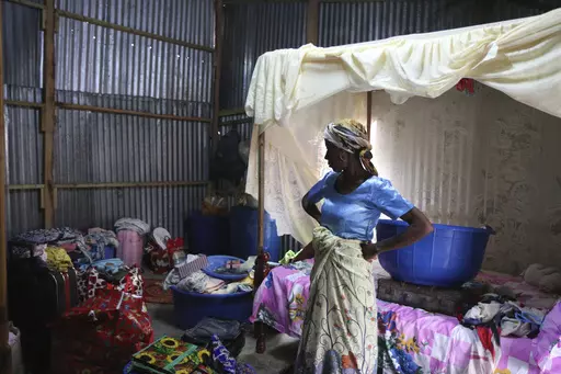 Zenabou S, a Comoros woman married to a French man in Mayotte and with French children, looks at her belongings as she prepares to move, in the Talus 2 district of Koungou, in the French Indian Ocean island of Mayotte Saturday, April 22, 2023. France is facing a migration quagmire on the island territory of Mayotte off Africa’s east coast. The government sent in 2,000 troops and police to carry out mass expulsions, destroy slums and eradicate violent gangs. But the operation has become bogged 