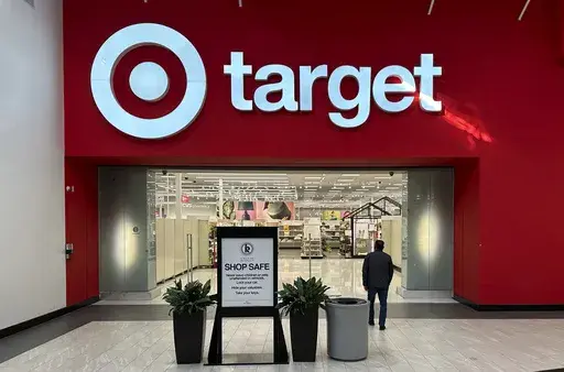A shopper heads into a Target store Jan. 11, 2024, in Lakewood, Colo. Target plans on cutting prices on thousands of consumer basics this summer, goods ranging from diapers to milk, with more Americans paying closer attention to their spending as inflation cuts into household budgets. (AP Photo/David Zalubowski, File)